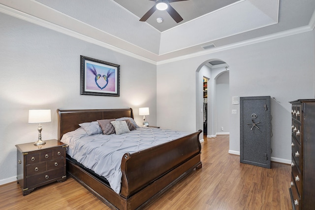 12341 NW 78th Mnr, Parkland, FL 33076 - bedroom with a tray ceiling, arched walkways, wood finished floors, baseboards, and ornamental molding