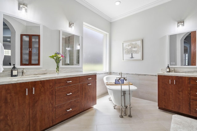 12341 NW 78th Mnr, Parkland, FL 33076 - full bath featuring a soaking tub, tile walls, two vanities, a wainscoted wall, and crown molding