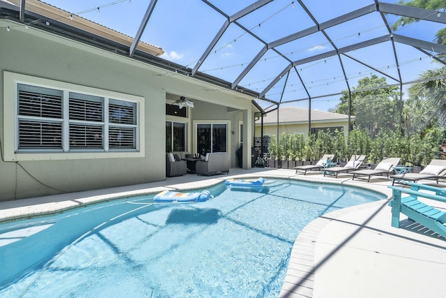 12341 NW 78th Mnr, Parkland, FL 33076 - swimming pool featuring a ceiling fan, a patio area, an outdoor hangout area, and glass enclosure