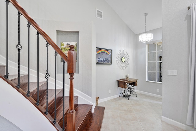 12341 NW 78th Mnr, Parkland, FL 33076 - foyer featuring stairway, a chandelier, vaulted ceiling, baseboards, and light tile patterned floors