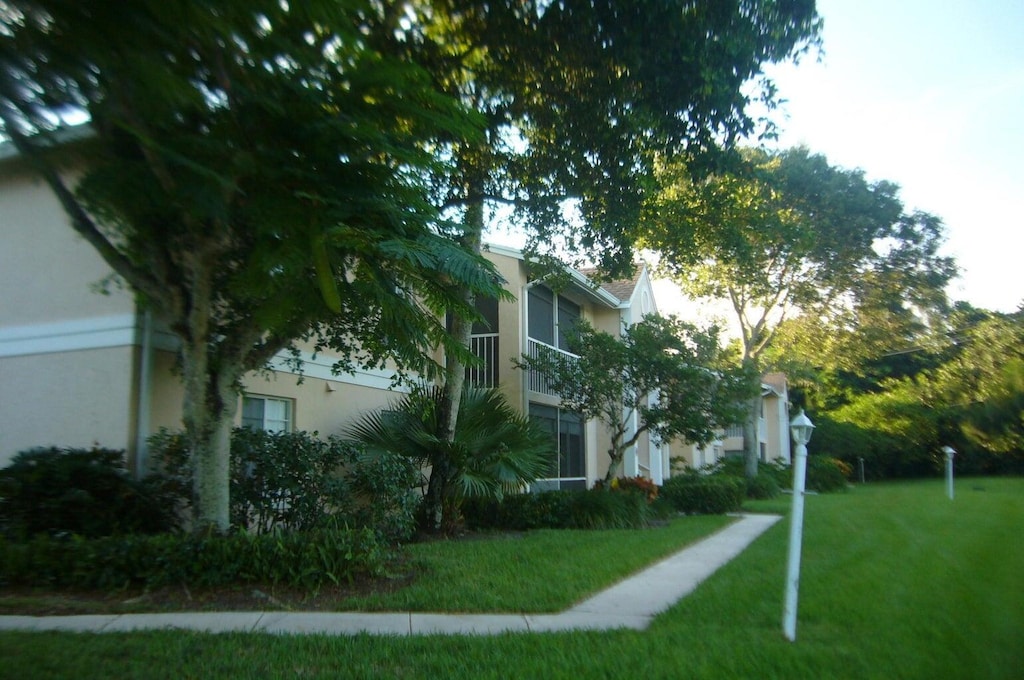 view of home's exterior featuring a lawn and stucco siding