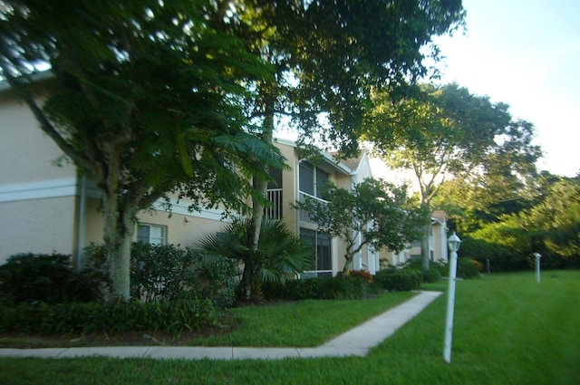view of home's exterior featuring a lawn and stucco siding