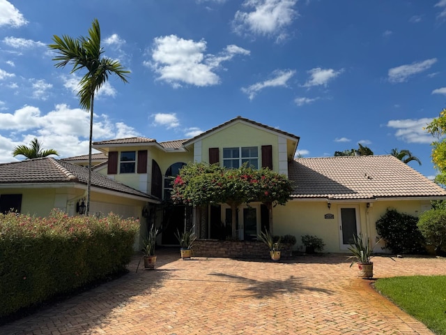 14324 Paddock Dr, Wellington, FL 33414 - traditional-style house with a tile roof and stucco siding
