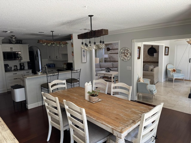 14324 Paddock Dr, Wellington, FL 33414 - dining space featuring arched walkways, a textured ceiling, a ceiling fan, and ornamental molding