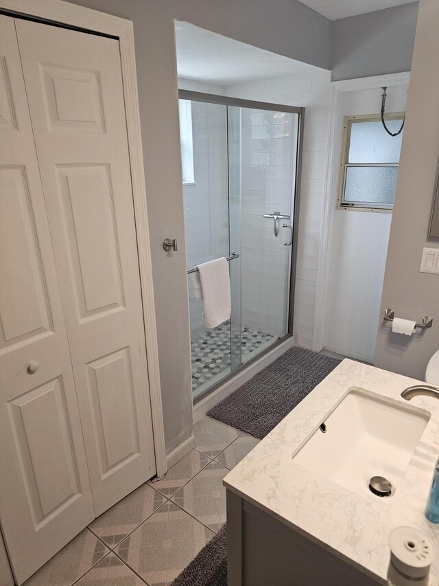 389 SE Whitmore Dr, Port Saint Lucie, FL 34984 - full bathroom featuring a stall shower, vanity, and granite tiled floors