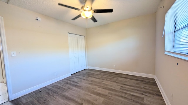 4061 N Dixie Hwy Unit 3, Oakland Park, FL 33334 - unfurnished bedroom featuring wood finished floors, a closet, baseboards, a textured ceiling, and a ceiling fan