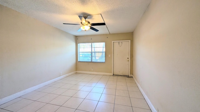 4061 N Dixie Hwy Unit 3, Oakland Park, FL 33334 - unfurnished room featuring a ceiling fan, a textured ceiling, light tile patterned floors, and baseboards