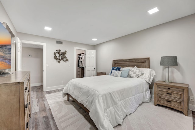 10001 W Atlantic Blvd Unit 319, Coral Springs, FL 33071 - bedroom featuring light wood-type flooring, baseboards, a walk in closet, recessed lighting, and a closet