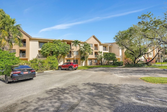 10001 W Atlantic Blvd Unit 319, Coral Springs, FL 33071 - view of property featuring uncovered parking and a residential view