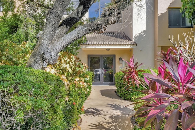 10001 W Atlantic Blvd Unit 319, Coral Springs, FL 33071 - entrance to property with french doors, stucco siding, and a tile roof