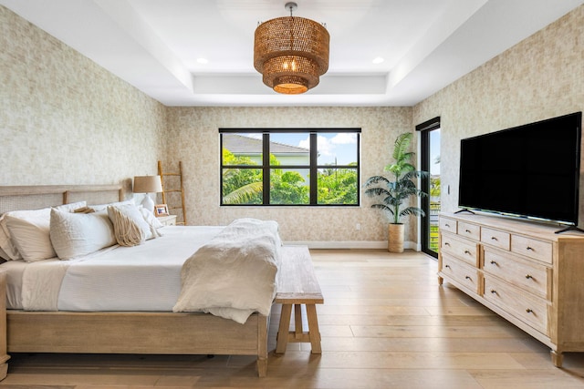 8294 Fishhawk Falls Ct, Boca Raton, FL 33496 - bedroom featuring wallpapered walls, multiple windows, light wood finished floors, and a raised ceiling