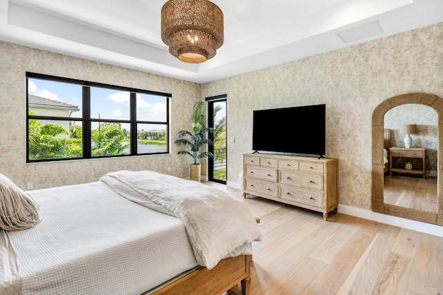 8294 Fishhawk Falls Ct, Boca Raton, FL 33496 - bedroom with wallpapered walls, light wood-style flooring, access to exterior, baseboards, and a raised ceiling