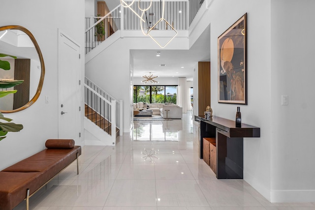 8294 Fishhawk Falls Ct, Boca Raton, FL 33496 - tiled foyer with stairway, a high ceiling, baseboards, and a chandelier