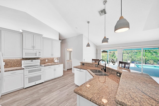 139 NE Royce Ave, Port Saint Lucie, FL 34983 - kitchen featuring white appliances, a sink, backsplash, light wood-type flooring, and stone counters