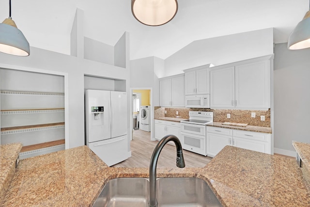 139 NE Royce Ave, Port Saint Lucie, FL 34983 - kitchen with white appliances, a sink, backsplash, light wood-style flooring, and white cabinets