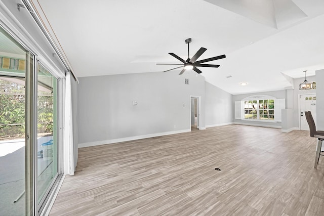 139 NE Royce Ave, Port Saint Lucie, FL 34983 - unfurnished living room with lofted ceiling, light wood finished floors, baseboards, and ceiling fan