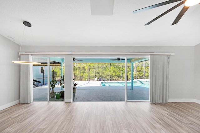 139 NE Royce Ave, Port Saint Lucie, FL 34983 - spare room featuring ceiling fan, baseboards, wood finished floors, a sunroom, and lofted ceiling