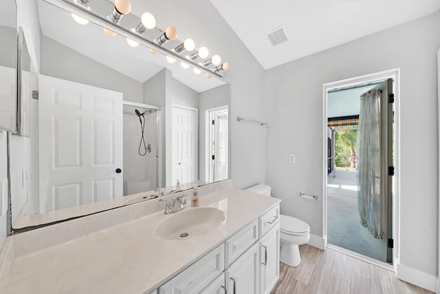 139 NE Royce Ave, Port Saint Lucie, FL 34983 - full bath with lofted ceiling, toilet, wood finished floors, vanity, and a shower