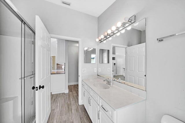 139 NE Royce Ave, Port Saint Lucie, FL 34983 - full bath with a shower stall, vanity, wood finished floors, and toilet