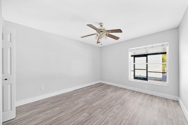 139 NE Royce Ave, Port Saint Lucie, FL 34983 - empty room with wood finished floors, a ceiling fan, and baseboards