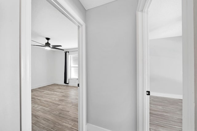 139 NE Royce Ave, Port Saint Lucie, FL 34983 - corridor with baseboards and wood finished floors