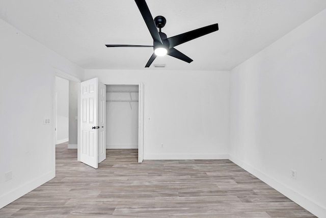 139 NE Royce Ave, Port Saint Lucie, FL 34983 - unfurnished bedroom with a closet, wood finished floors, baseboards, and ceiling fan