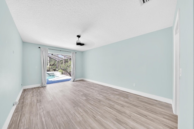 139 NE Royce Ave, Port Saint Lucie, FL 34983 - spare room featuring light wood-style floors, baseboards, and a textured ceiling