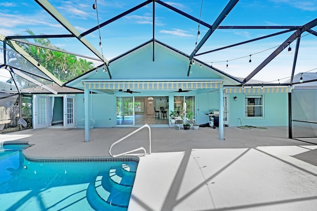 139 NE Royce Ave, Port Saint Lucie, FL 34983 - outdoor pool with a ceiling fan, a patio area, grilling area, and glass enclosure