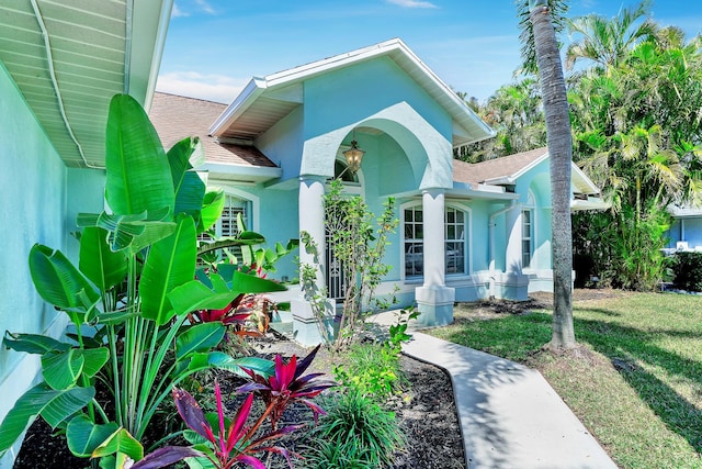 139 NE Royce Ave, Port Saint Lucie, FL 34983 - view of front facade with stucco siding, roof with shingles, and a front yard