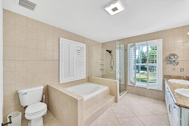 139 NE Royce Ave, Port Saint Lucie, FL 34983 - bathroom with tile walls, a shower stall, tile patterned flooring, vanity, and toilet