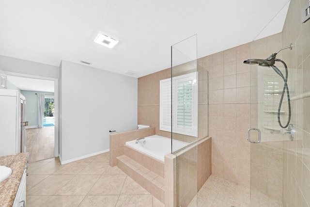 139 NE Royce Ave, Port Saint Lucie, FL 34983 - bathroom with a stall shower, tile patterned flooring, vanity, and a garden tub