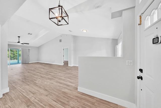 139 NE Royce Ave, Port Saint Lucie, FL 34983 - entrance foyer with baseboards, vaulted ceiling, a chandelier, light wood finished floors, and ceiling fan