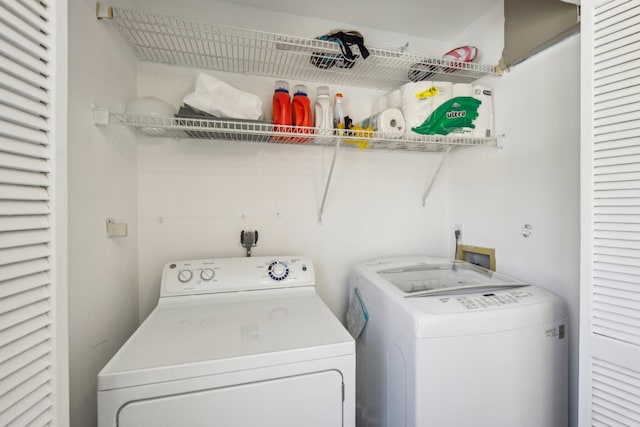 clothes washing area featuring washing machine and clothes dryer
