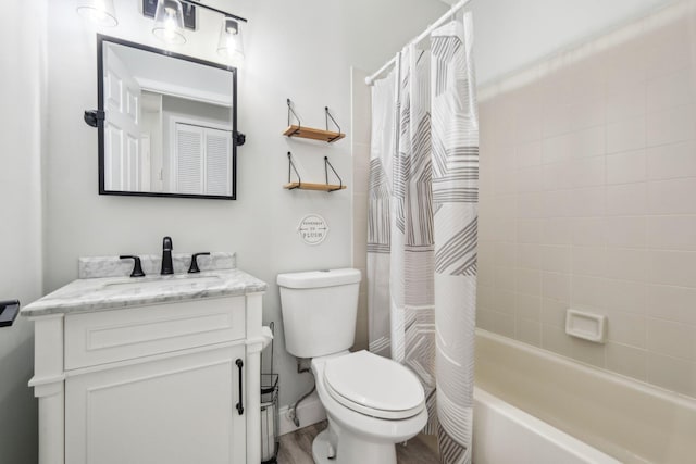 full bath with toilet, vanity, and shower / bath combo