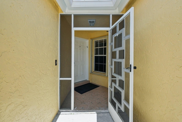 property entrance featuring stucco siding