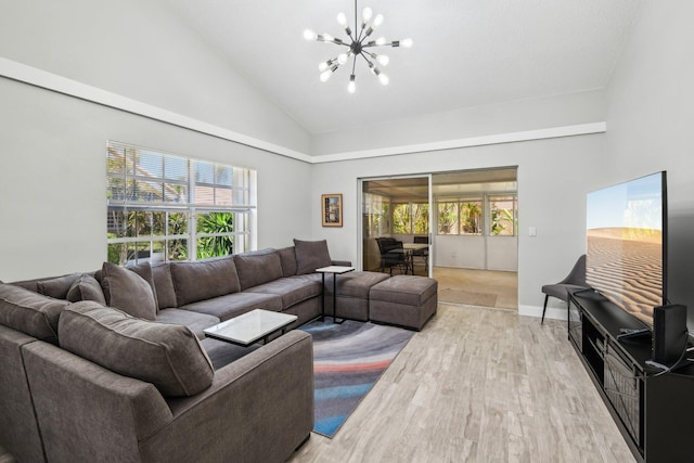 living area with a chandelier, light wood-style floors, high vaulted ceiling, and baseboards