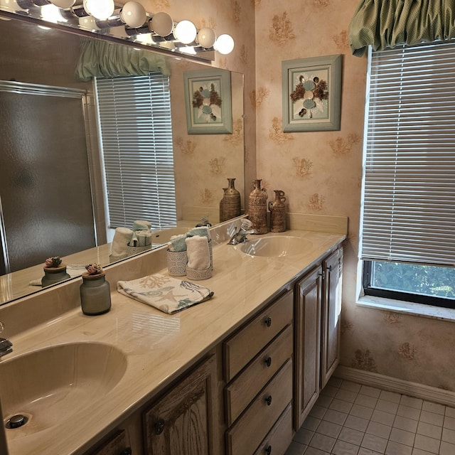1779 W Royal Tern 1 Ln Unit 1, Fort Pierce, FL 34982 - full bathroom with tile patterned flooring, wallpapered walls, baseboards, double vanity, and a shower stall