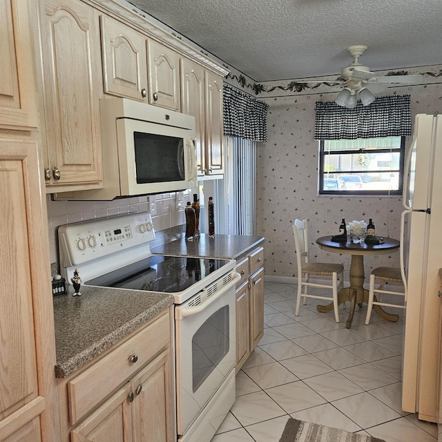 1779 W Royal Tern 1 Ln Unit 1, Fort Pierce, FL 34982 - kitchen featuring white appliances, light brown cabinets, dark countertops, a ceiling fan, and light tile patterned floors