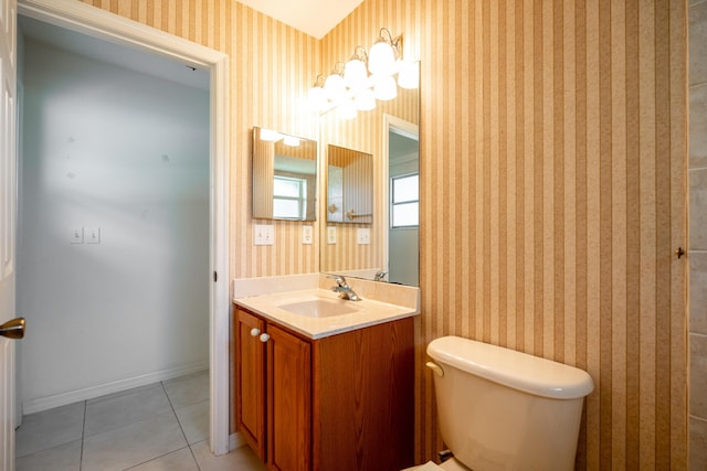 620 SE Stow Ter, Port Saint Lucie, FL 34984 - bathroom featuring wallpapered walls, toilet, vanity, tile patterned floors, and baseboards