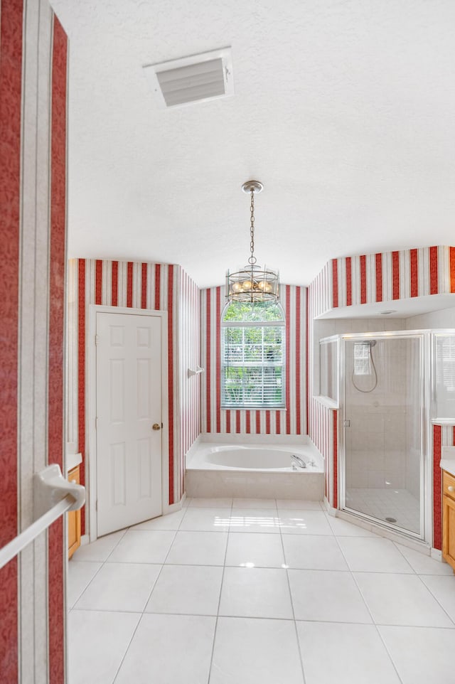 620 SE Stow Ter, Port Saint Lucie, FL 34984 - bathroom featuring wallpapered walls, a shower stall, tile patterned floors, a bath, and a chandelier