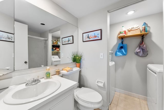 full bath with independent washer and dryer, toilet, a shower stall, baseboards, and vanity