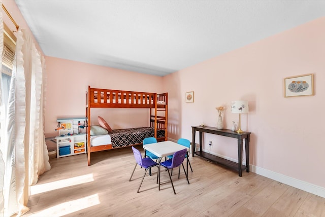bedroom featuring wood finished floors and baseboards