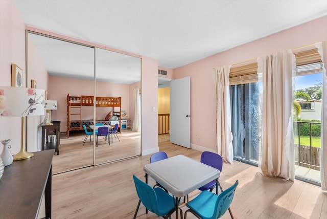 dining space featuring light wood-style flooring and baseboards