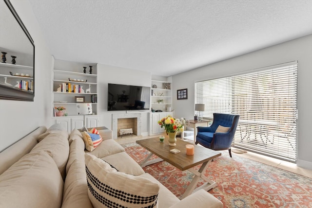 living area featuring a textured ceiling and built in features