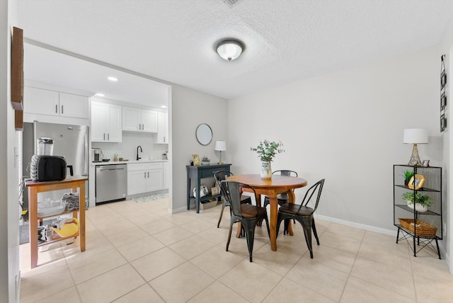 dining room with light tile patterned flooring, baseboards, recessed lighting, and a textured ceiling