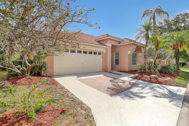 3035 Casa Rio Ct, Riviera Beach, FL 33418 - mediterranean / spanish-style home featuring stucco siding, driveway, a garage, and a tile roof