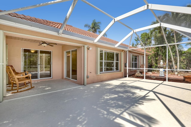 3035 Casa Rio Ct, Riviera Beach, FL 33418 - rear view of house featuring ceiling fan, a patio area, a tiled roof, and stucco siding