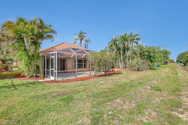 3035 Casa Rio Ct, Riviera Beach, FL 33418 - view of green lawn featuring a patio area and glass enclosure