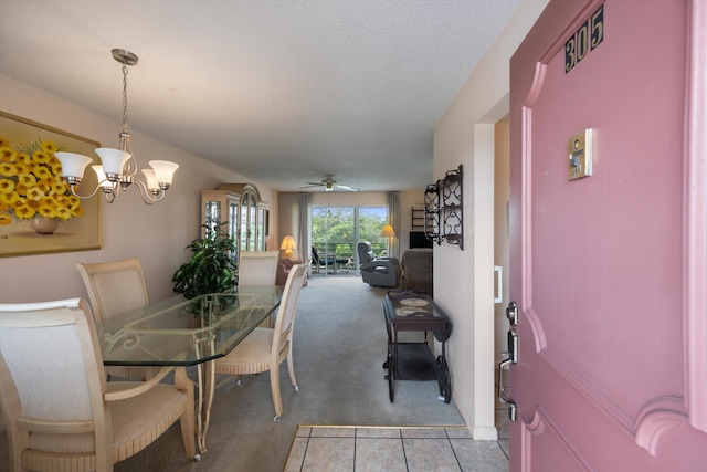 dining space featuring light carpet, a chandelier, and ceiling fan