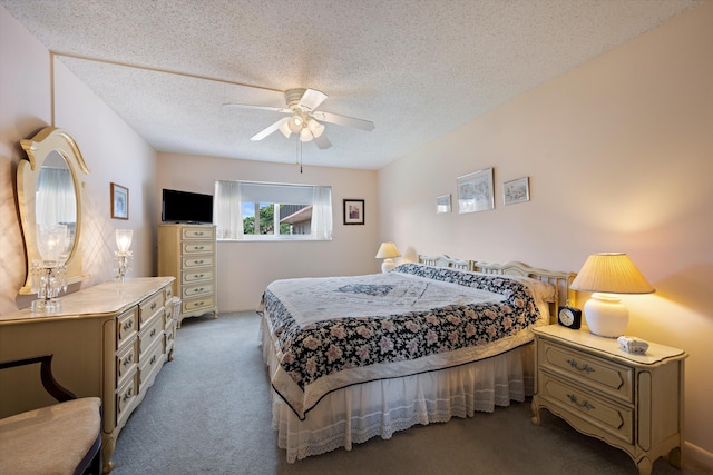 carpeted bedroom featuring a ceiling fan and a textured ceiling